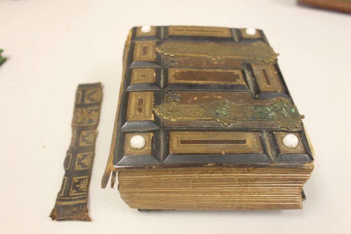 Photograph album with tooled leather and brass cover,: Photograph album with tooled leather and brass cover, with 25 sleeves. 5 1/2 X 7" with damaged spine. Photographers include Lundy of Cincinnati, Mrs. R. Cooper & Son, Maysville, KY, Cadwallader's Mays
