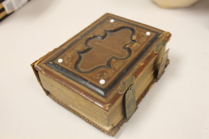 Tooled leather and brass photo album marked Bettie C. L: Photograph album with tooled leather and brass cover, marked Bettie C. Lashbrooke, with damaged spine, 30 pages. Photographers include Landy, Cincinnati; D. Hinkle, Germantown; Mrs. R. Cooper and Son,