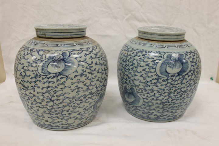 Pair of Chinese blue/gray floral decorated earthenware: Pair of Chinese blue/gray floral decorated earthenware covered jars. 9 1/2" tall