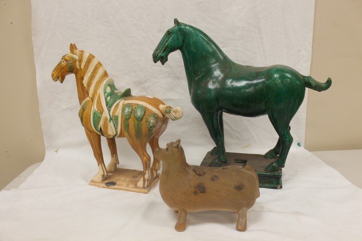 Chinese earthenware animals: Chinese earthenware animals including primitive cow with incised markings, app. 7 1/4" tall, and two horses, larger green horse is app. 16 1/2" tall and 17" long