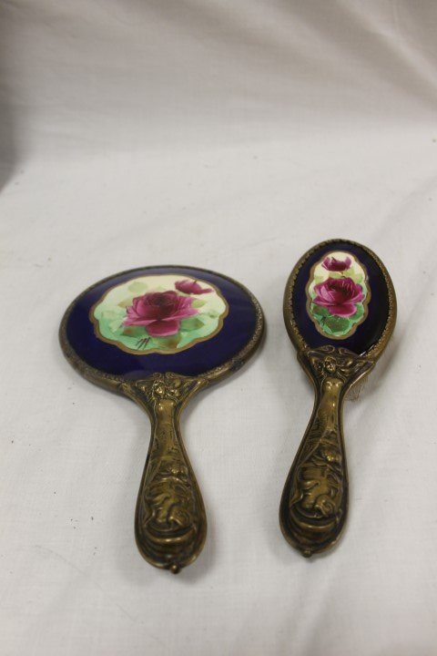 Art Nouveau brush and mirror with hand painted roses: Art Nouveau brush and mirror with hand painted rose decorated backs and embossed brass Mermaid handles front and back. Mirror is 9 1/2" long.