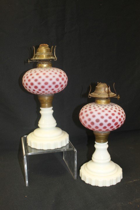 Pair oil lamps with milk glass base and cranberry: Pair oil lamps with milk glass base and cranberry opalescent coin dot fonts, app. 10" at filler top.