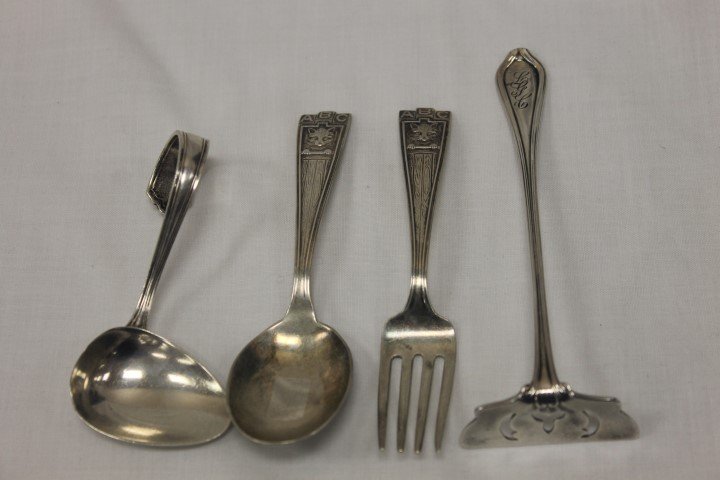Sterling silver items: Webster feeding spoon; Weidlich: Sterling silver items: Webster feeding spoon; Weidlich child's set in the ABC pattern with kitten; Towle "Paul Revere" 1906 baby food pusher. The food pusher has monogram LGC and the ABC spoon is date