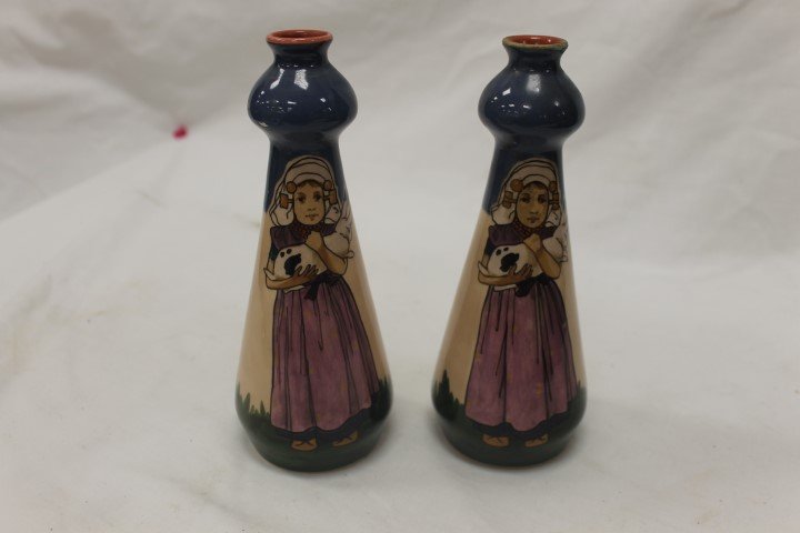Pair of Norica Pottery vases with young girl with a: Pair of Norica Pottery vases with young girl with a rabbit, 7 7/8" tall, one with minor glaze loss at left above the girls head.