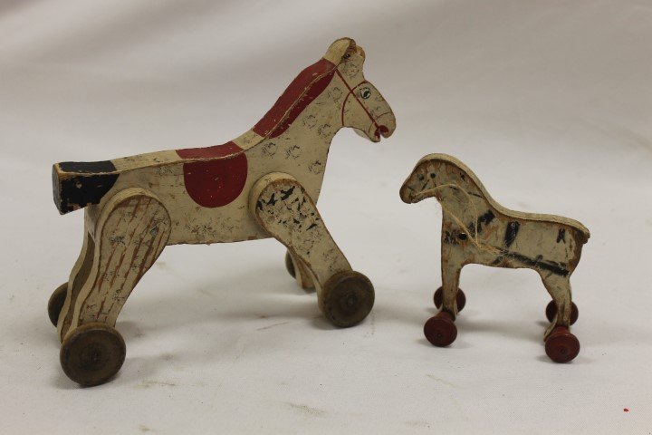 Painted wooden horse pull toy with expected wear, 8": Painted wooden horse pull toy with expected wear, 8" long, 6 5/8" tall; small horse pull toy with spool rollers, 4 3/8" tall, 4 1/4" long