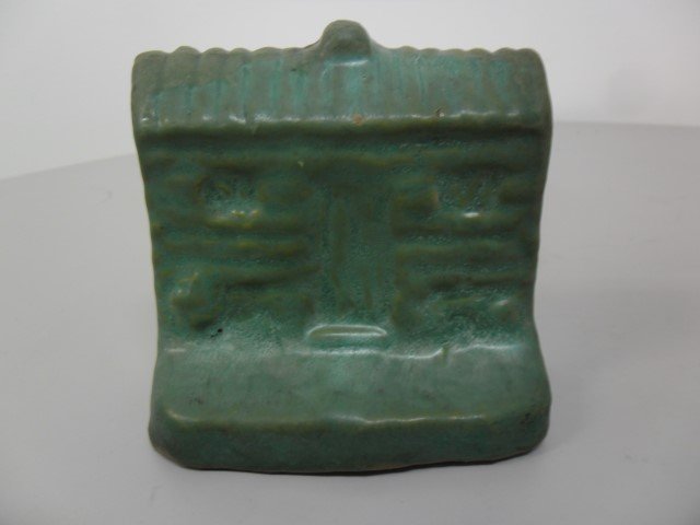 Genuine Bybee bookend/doorstop in matte green. A few: Genuine Bybee bookend/doorstop in matte green. A few chips on the back. Impressed Genuine Bybee mark, 4" tall, 4 1/5" wide.