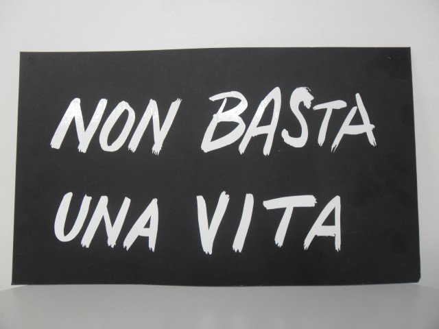 John Tuska, original workshop sign from his studio,: John Tuska, original workshop sign from his studio, "Non Basta Una Vita" (One Life is Not Enough). 17" wide, 10" tall. Purchased directly from the tuska estate.