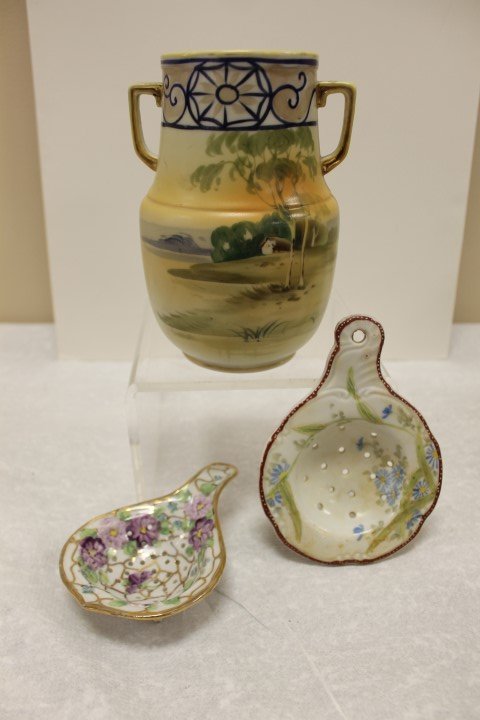 Nippon blue maple leaf mark 2 handle 6 3/8" landscape: Nippon blue maple leaf mark 2 handle 6 3/8" landscape vase, gold wear on handles and rim; unmarked tea strainer top; unmarked footed tea strainer with violet decoration.