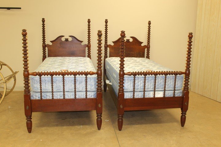 Pair of cherry spool turned beds with broken arch: Pair of cherry spool turned beds with broken arch pediment on headboard. With new Sealy Posturepedic bedding.