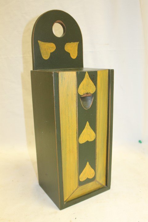 David T. Smith reproduction hanging candle box with: David T. Smith reproduction hanging candle box with sliding lid in green paint with yellow trim and five yellow hearts. 17 1/2" tall, 5 7/8" wide 5" deep