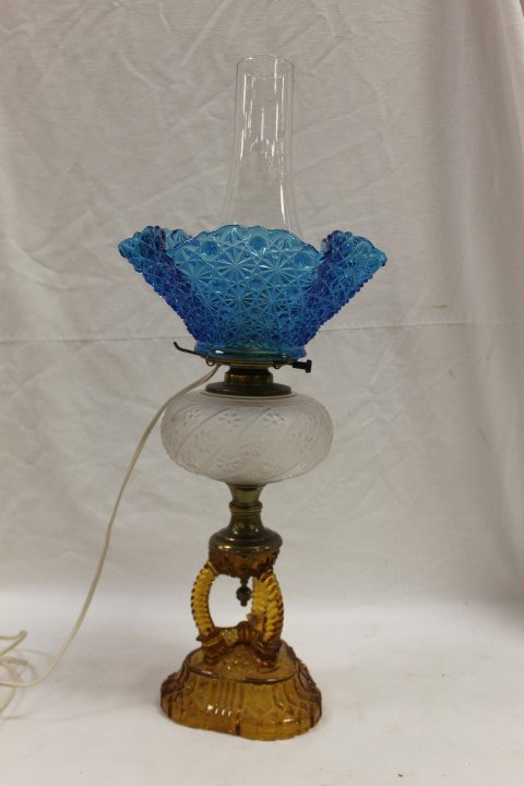 Cathedral lamp with amber base, frosted swirl and: Cathedral lamp with amber base, frosted swirl and daisty font, and blue Daisy & Button ruffle top shade. 17 1/2" tall to top of shade.