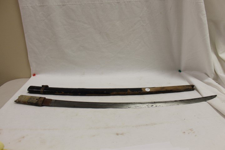 Japanese Wakisashi short sword with partial ray skin: Japanese Wakisashi short sword with partial ray skin handle wand sheath, both with damage. Pre WW2, blade with spotting, 31 1/2" long. No twists or dents on blade, rusting and discoloration more heavi