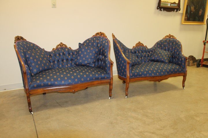 Pair of Victorian upholstered carved back settees, each: Pair of Victorian upholstered carved back settees, each with two cushions. Covered in matching upholstery.