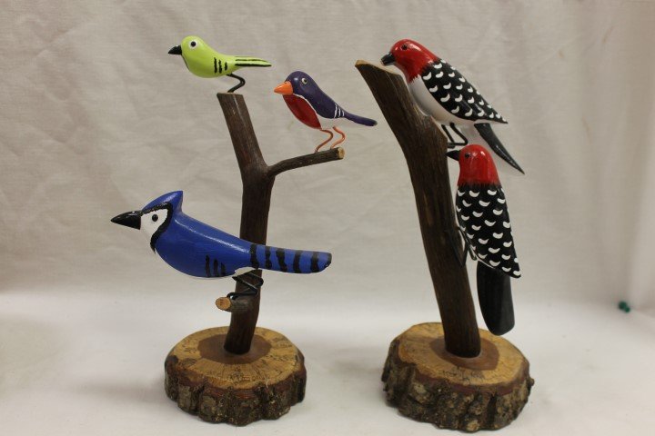 Lonnie and Twyla Money carved bird trees, one with (2): Lonnie and Twyla Money carved bird trees, one with (2) red headed woodpeckers (11 7/8"), and one with a Blue Jay and two other colorful birds (12 3/8"). Tip of beak missing on top woodpecker, minor pa