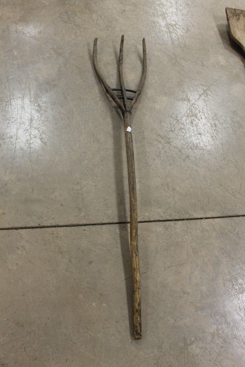 3-prong pitch fork mae from a single piece of wood.: 3-prong pitch fork mae from a single piece of wood. Remnants of old red paint, 51" long.