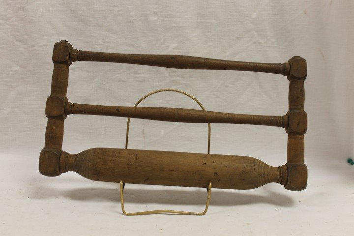 Unusual 2-handle framed rolling pin with turned: Unusual 2-handle framed rolling pin with turned supports and handles, 16 3/4" wide, 8 3/4" tall.