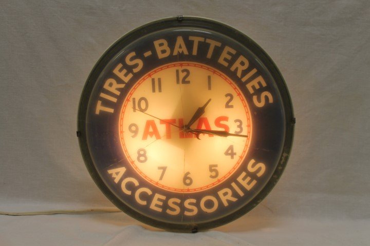 Atlas Tires-Batteries Accessories light-up clock with: Atlas Tires-Batteries Accessories light-up clock with cracked plastic face, app. 16" wide, Neon Products, Inc. Lima, Ohio. Plastic body with melted portion on one back side and heat crack spot on othe