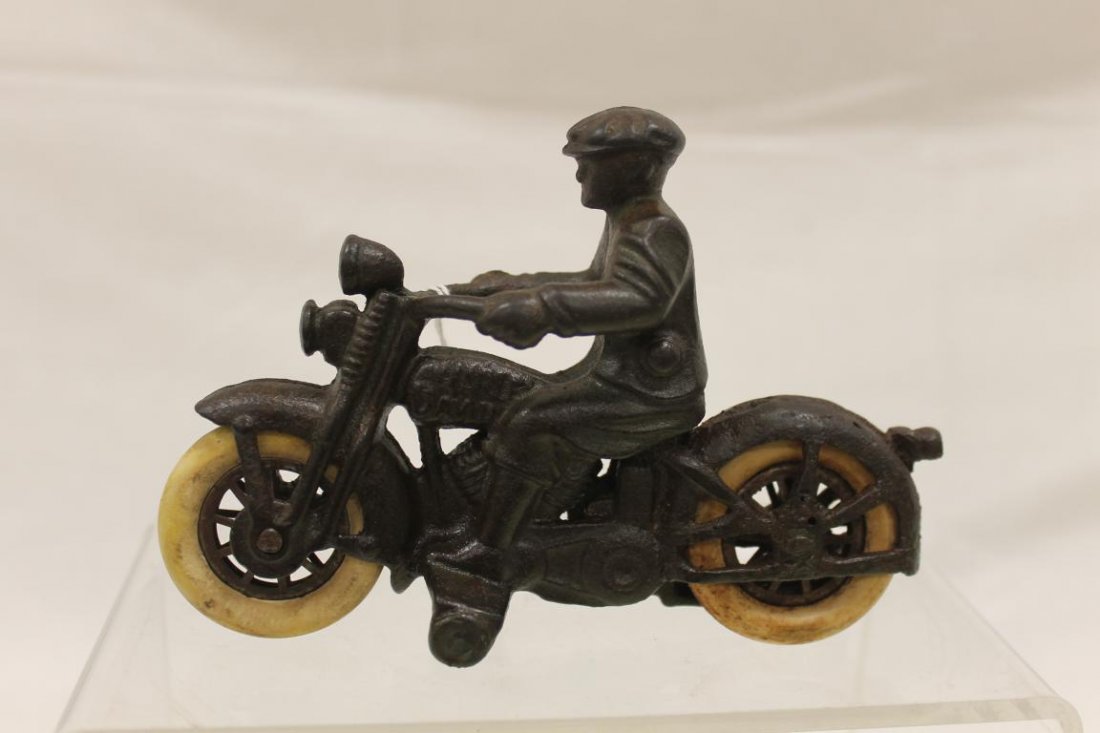 Harley Davidson cast iron motorcycle and rider with: Harley Davidson cast iron motorcycle and rider with rubber tires, app. 6" long, 4 1/4" tall.