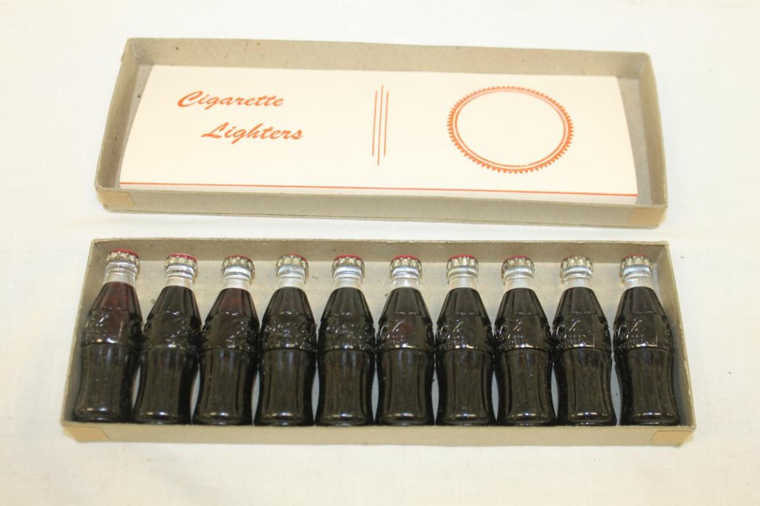 Set of (10) Coca-Cola cigarette lighters. New in the: Set of (10) Coca-Cola cigarette lighters. New in the original box.