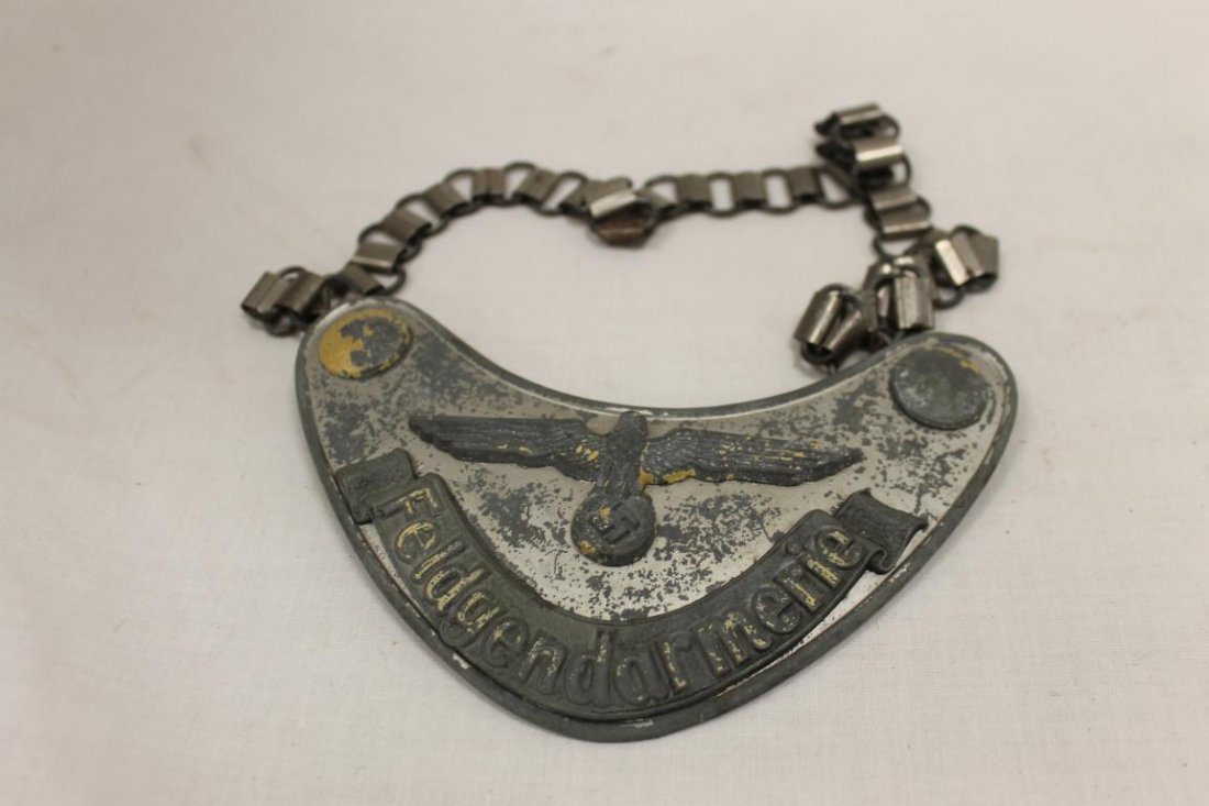 German WWII army Wehmacht Feldgendarmerie Gorget. Matt: German WWII army Wehmacht Feldgendarmerie Gorget. Matt silver lacquered shield with applied gray bandeau, with most of the luninous paint worn off. Marked CE Juneker Berlin on back clip. Aged felt on
