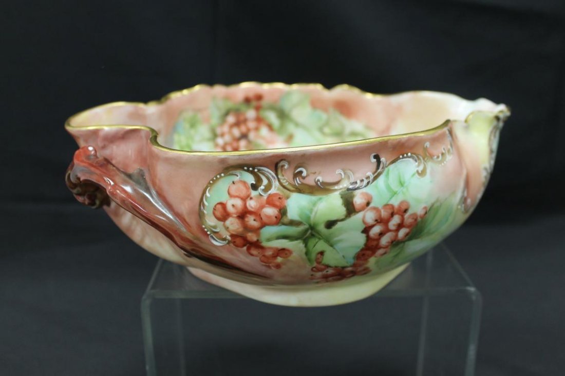 H&Co. Limoges handled center bowl with berry decoration: H&Co. Limoges handled center bowl with berry decoration and scroll and beaded enamel adornments with gold tim. 10 1/2" long, 8 1/2" wide, 3 3/4" tall