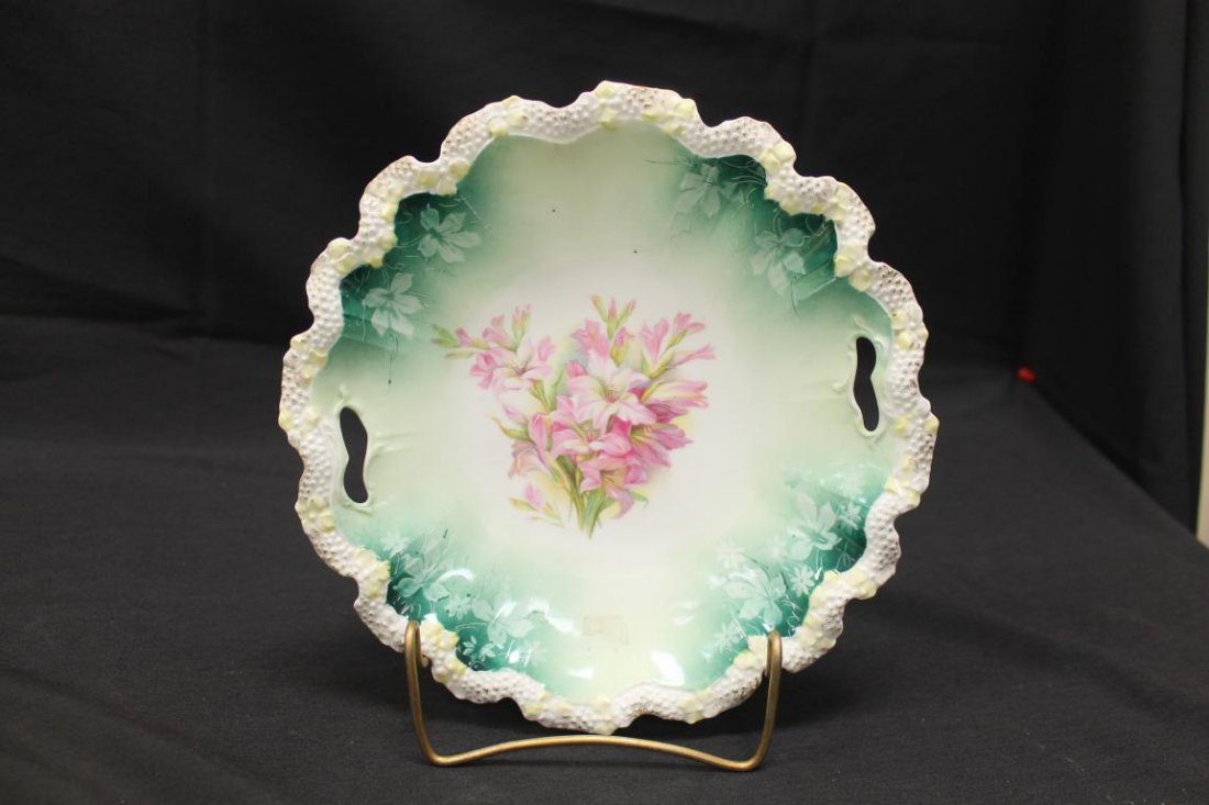 Unmarked RS Prussia deep cake plate with ring mold: Unmarked RS Prussia deep cake plate with ring mold mark, stippled floral border, with floral decoration on a green background, 9 3/4"
