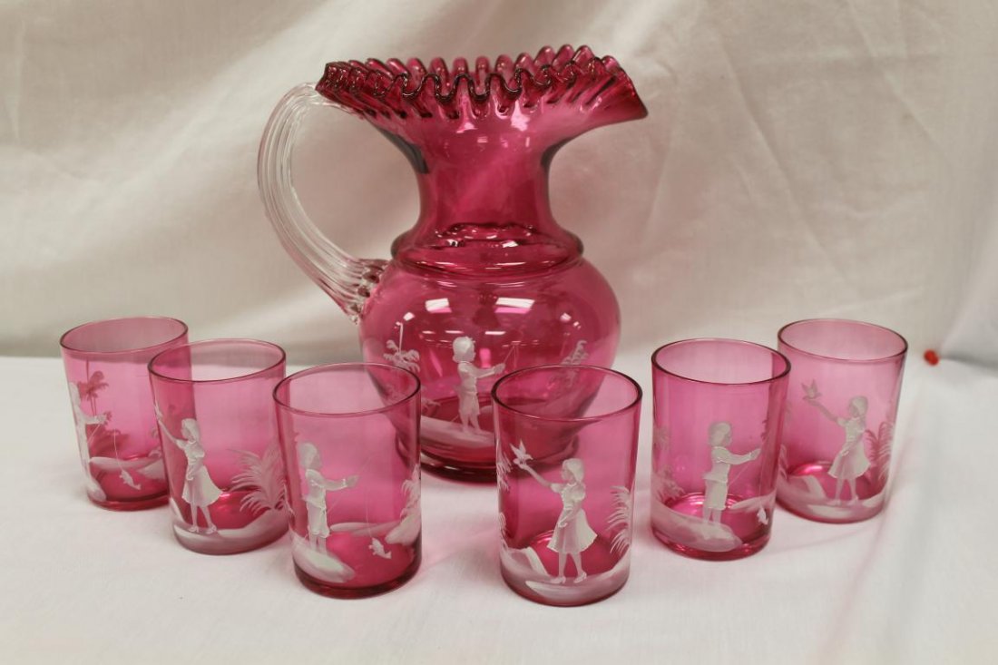 Cranberry 7 pc. Mary Gregory style water set with: Cranberry 7 pc. Mary Gregory style water set with decoratin of a young boy fishing and of a young girl with a dove. 9 1/2" crimped rim pitcher with applied clear reeded handle decorated with the fishe