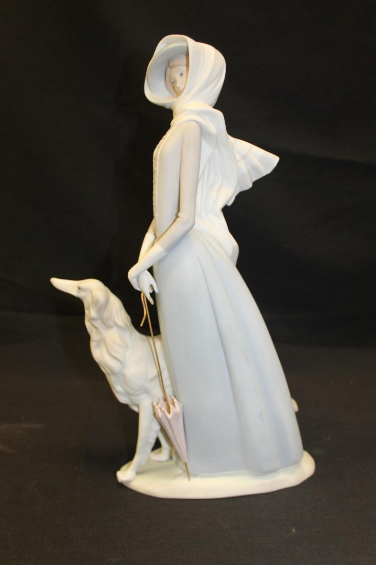 Lladro figure of a lady with umbrella and dog, 15 3/4".: Lladro figure of a lady with umbrella and dog, 15 3/4".