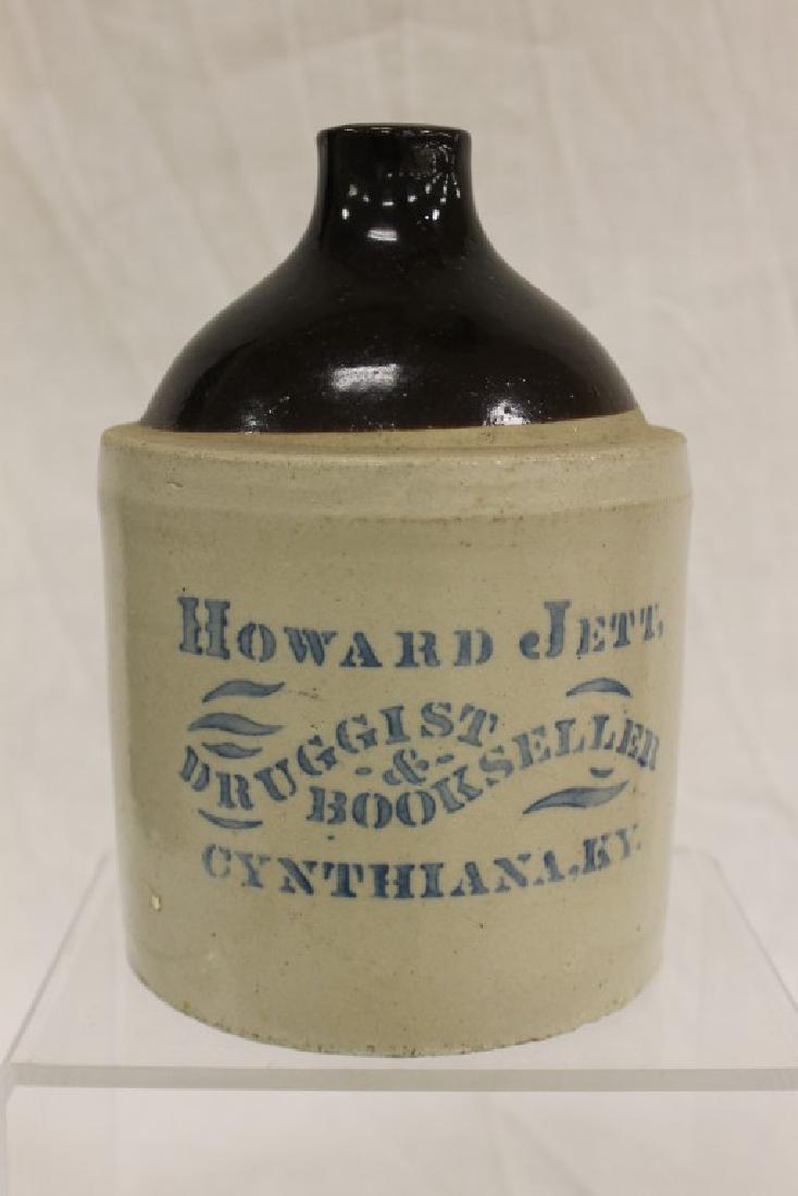 RARE!!! Brown and white advertising jug "Howard jett,: RARE!!! Brown and white advertising jug "Howard jett, Druggist & Bookseller Cynthiana, KY". Great, clear stencil on an exceptionally rare jug. Minor rim wear. App. 1/2 gallon.