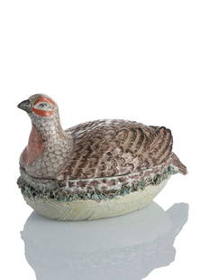 LIDDED TURREN IN SHAPE OF A QUAIL ON A NEST: LIDDED TURREN IN SHAPE OF A QUAIL ON A NESTGera, circa 1790L. 16,5 cmWithout mark, ‘P.54.’ in black on the underside. Polychrome painted. Repaired lid and wings, damaged tail feathers,