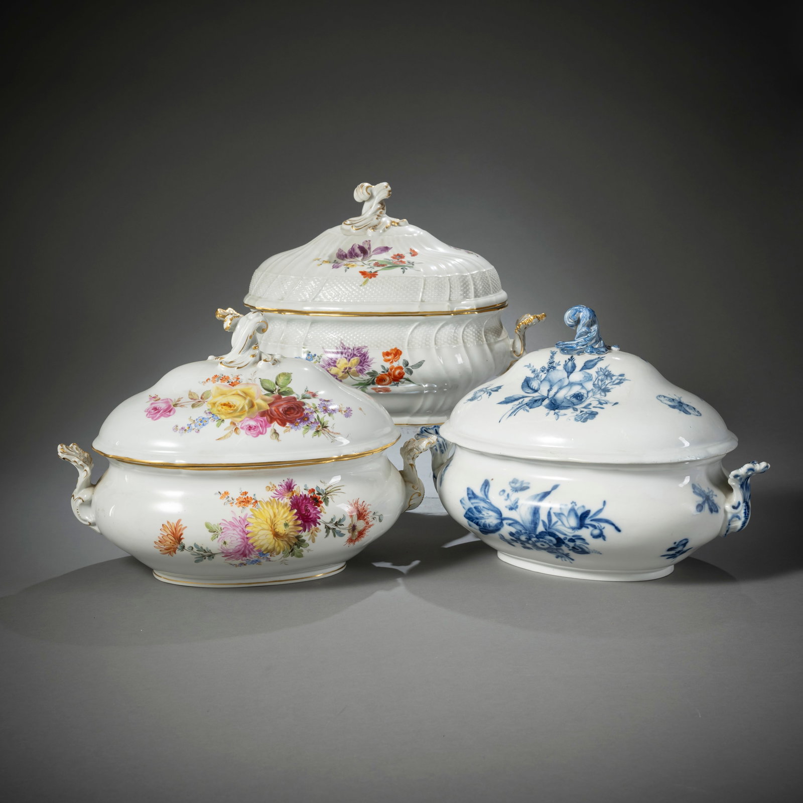 THREE MEISSEN FLORAL PAINTED TUREENS AND COVERS: THREE MEISSEN FLORAL PAINTED TUREENS AND COVERS19th century to 1934L. 38 x 28 cmPolychrome and blue flowers, blue crossed sword marks, one with dot, 2 tureens of 2nd/3rd choice. Blue painted tureen re