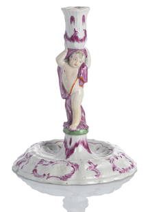 A ROCOCO CANDLESTICK: A ROCOCO CANDLESTICKWallendorf, circa 1770H. 20 cmThe moulded stand with Ozier relief, a putto as spout support, without mark. Chips, restored on the shaft.Jan Ahlers