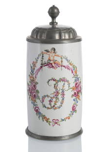 A LARGE PEWTER MOUNTED TANKARD: A LARGE PEWTER MOUNTED TANKARDIlmenau (?), circa 1775H. 26,5 cmDecorative floral monogram surrounded by floral garlands and a putto, without mark. Minor wear.Jan Ahlers CollectionWalzenkrugIlmenau
