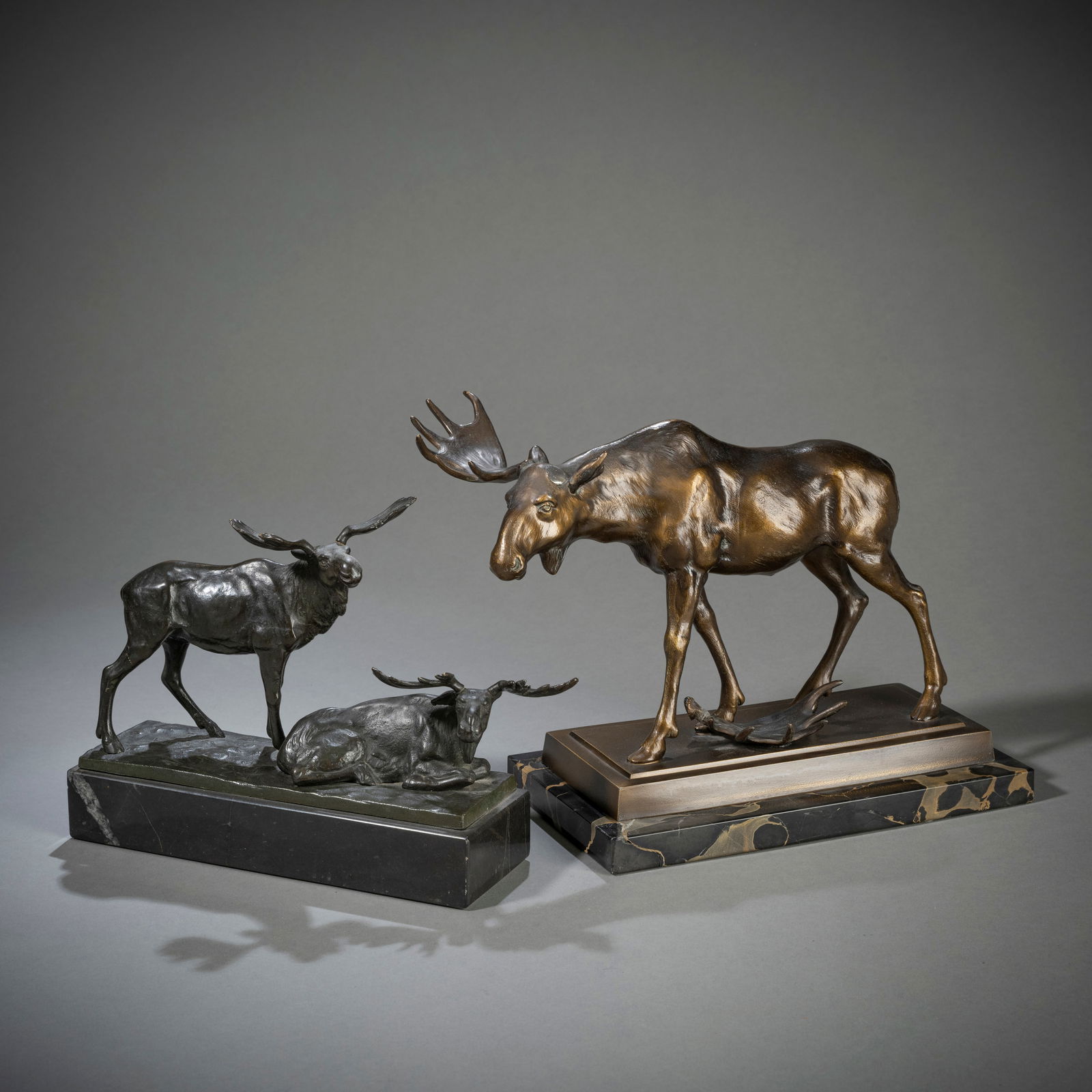 TWO ANIMAL FIGURES - ELKS: TWO ANIMAL FIGURES - ELKS20th centuryL. 26/29 cmA pair of elks by Franz Iffland (1862-1935), bronze, patinated, signed and black stone base. Antlers slightly loose, chips. Elk with lost antler anonymo