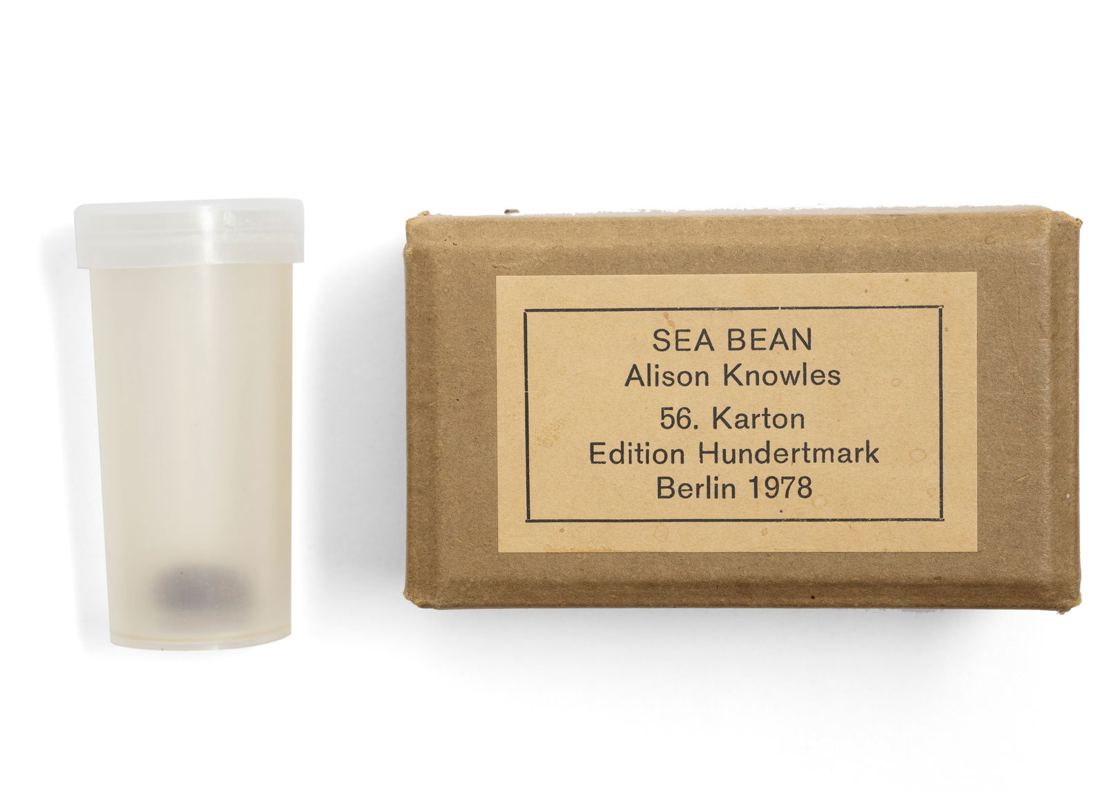 Knowles, Alison: Knowles, AlisonNew York, 19335,5 x 9,5 x 5 cm"Sea bean", 1978. Bean in plastic film roll, in original cardboard box. Multiple. Signed in ink on an inserted sheet of paper, numbered 40/80 and titled as