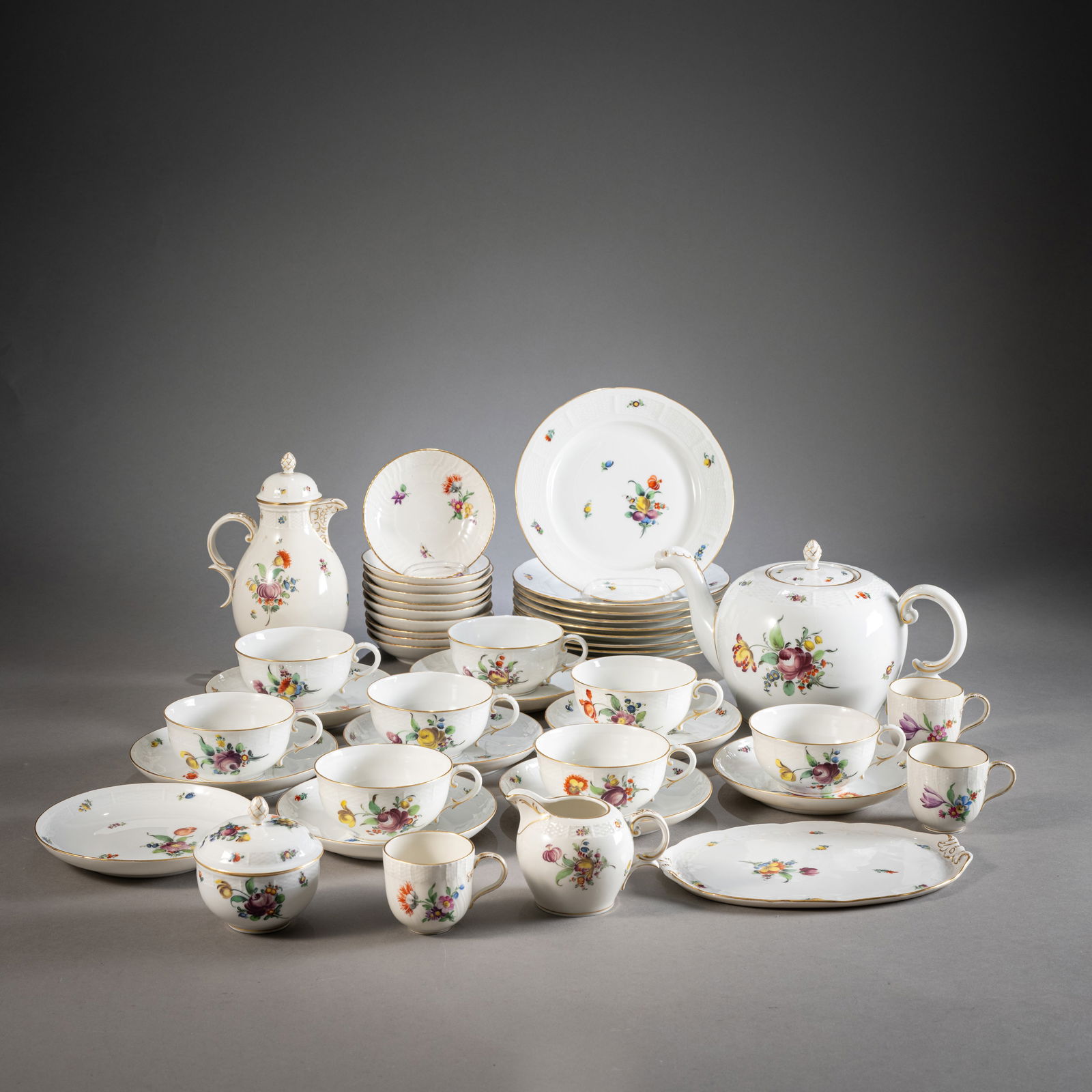 A MIXED LOT OF FLORAL PAINTED PORCELAIN: A MIXED LOT OF FLORAL PAINTED PORCELAINmostly Nymphenburg, 20th centurydivers9 plates, 8 cups, 9 saucers, teapot, coffee pot, sugar bowl, milk jug, small tray. Pressed diamond-shaped shields, stamp ma