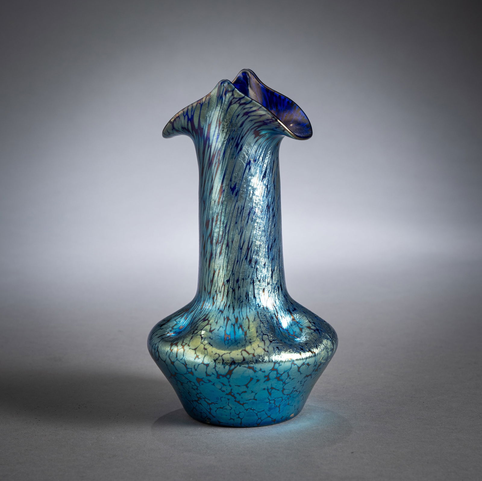 A LOETZ PAPILLON PATTERN VASE: A LOETZ PAPILLON PATTERN VASELoetz Wwe., Klostermühle, circa 1900H. 19,5 cmBlue-violet glass with melted silver crumbling, minor wear.Vase mit Papillon DekorLoetz Wwe., Klostermühle, um 1900