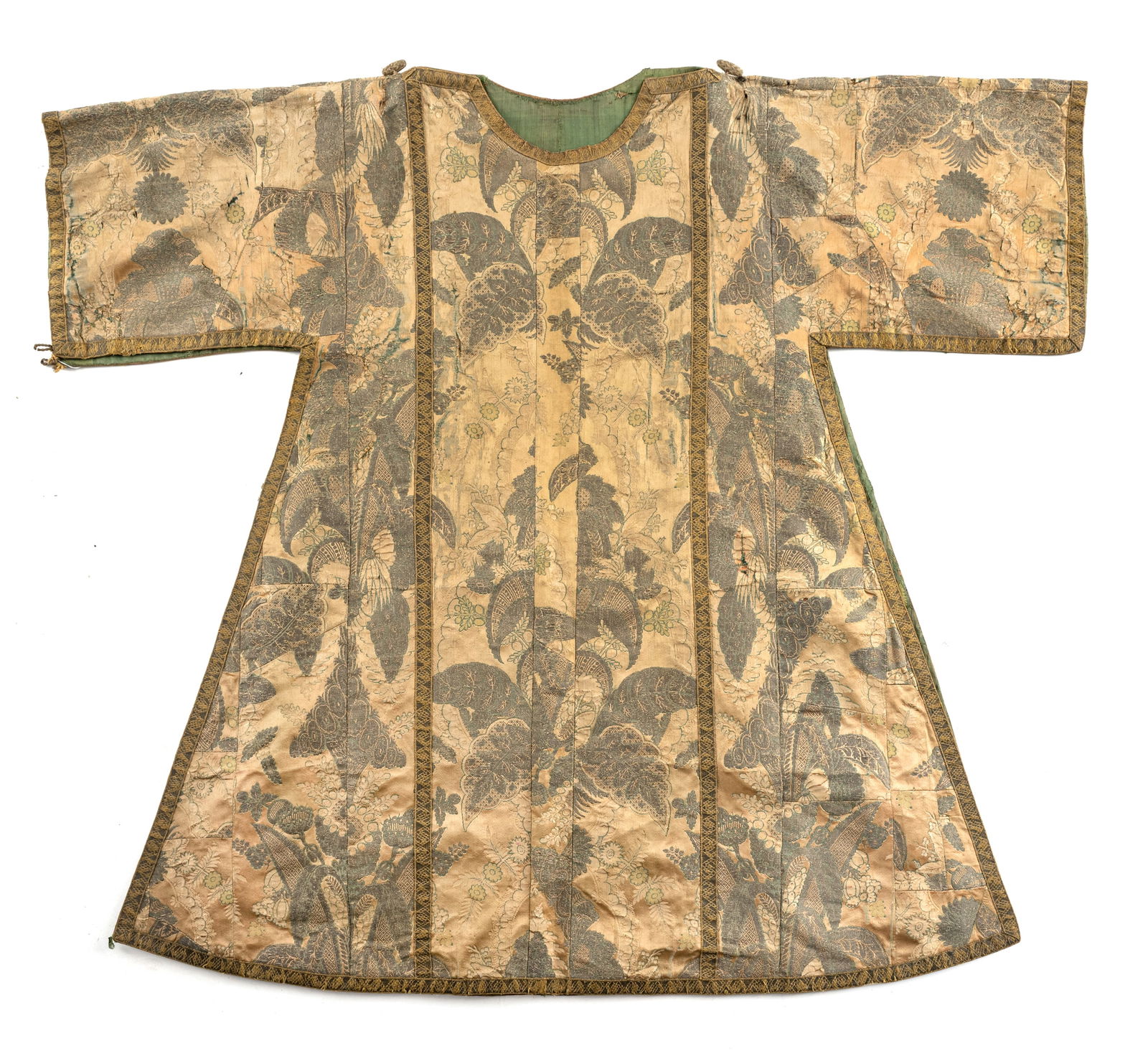 A PRIEST VESTMENT - DALMATIC: A PRIEST VESTMENT - DALMATICEurope, 18th/19th centuryL. 118 cm, B. 105 cmBrownish beige, formerly dark green silk fabric, additional pattern weft: silver thread, appliquéd gold borders. Lining: g