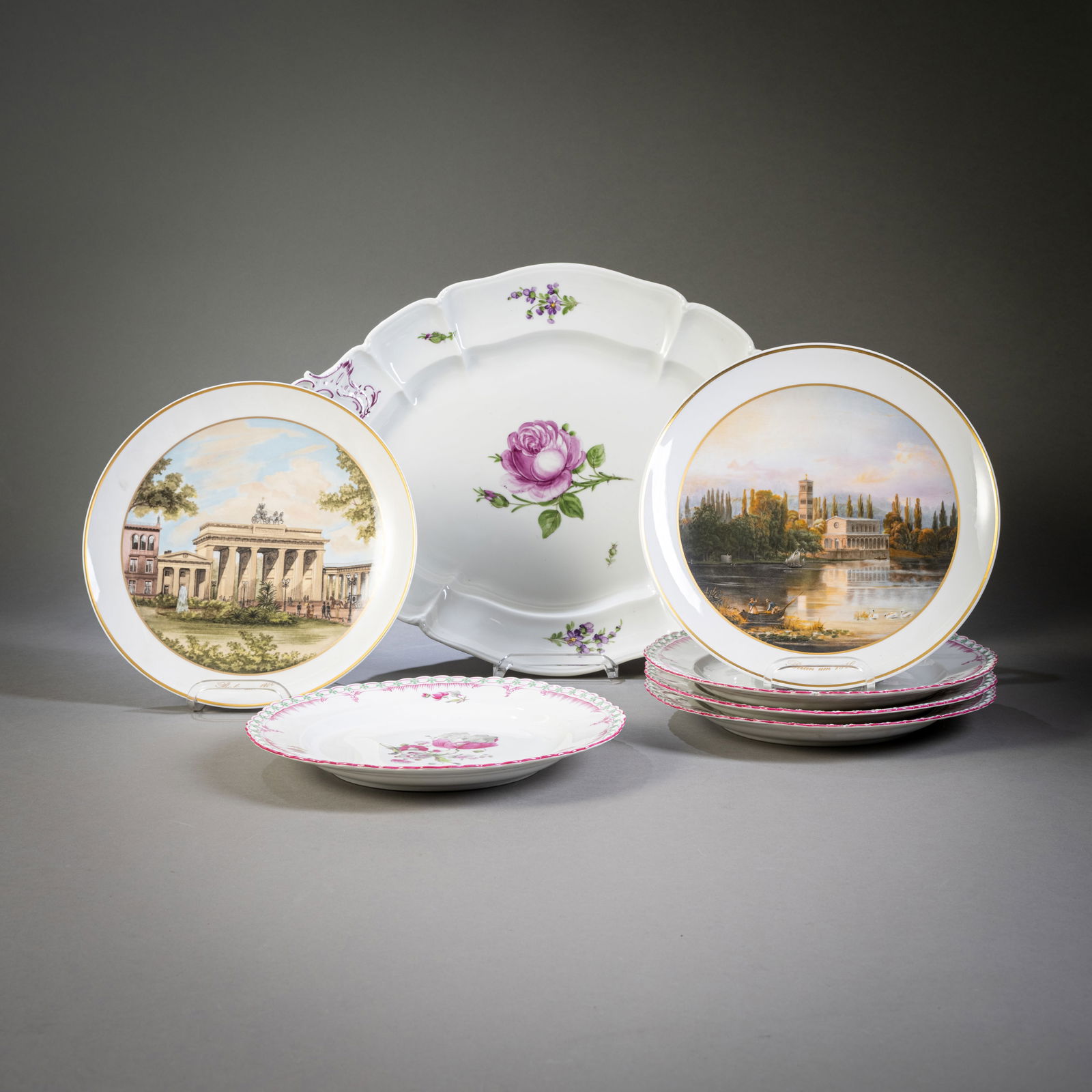 TRAY AND SIX PLATES, KPM AND NYMPHENBURG: TRAY AND SIX PLATES, KPM AND NYMPHENBURG Berlin/Nymphenburg, 20th century. D. 25/L. 45 cm 2 wall plates by KPM with historical views of Berlin, blue sword mark, black imperial orb mark. 4 plates by