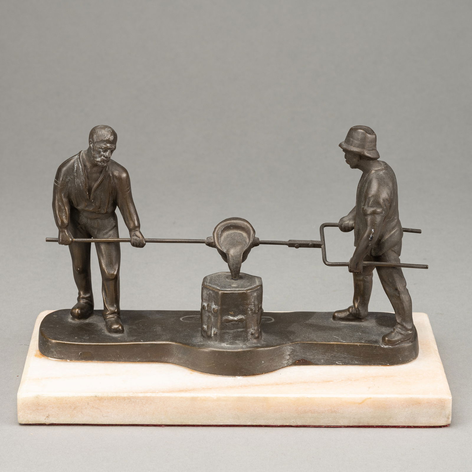 TWO STEEL CASTER: TWO STEEL CASTER Gelsenguss, Gelsenkirchen, circa 1920/30 L. 21/22,5 cm Bronze, patinated, inscribed. White marble plinth. Chipped The Finck CollectionZwei Stahlgiesser Firma Gelsenguss,