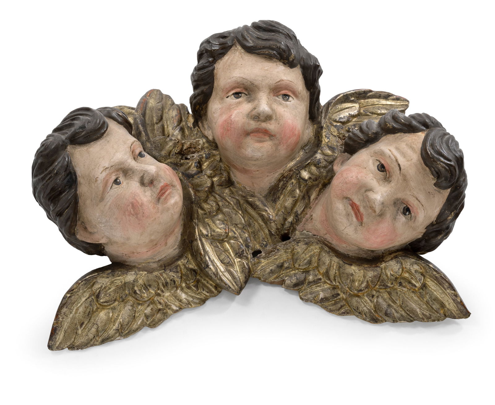 A GROUP OF THREE PUTTO HEADS: A GROUP OF THREE PUTTO HEADS 18th century L. 48 cm Limewood, carved with flattened back. Later polychromy with a few losses. Rest., damages due to age.Gruppe von drei Puttenköpfen 18.
