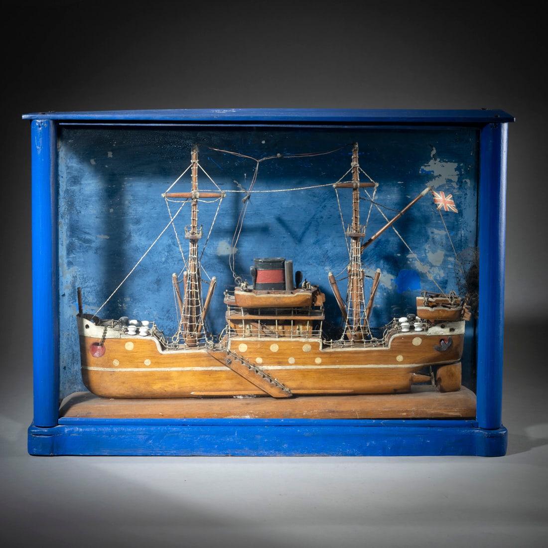 A SHIP MODEL IN A WOODEN BOX: A SHIP MODEL IN A WOODEN BOX probably circa 1900 40 x 56 x 14,5 cm Painted wooden box with glass display front. The ship of wood and sythetics.Modellschiff im Schaukasten wohl um 1900 40 x 56 x 14,5