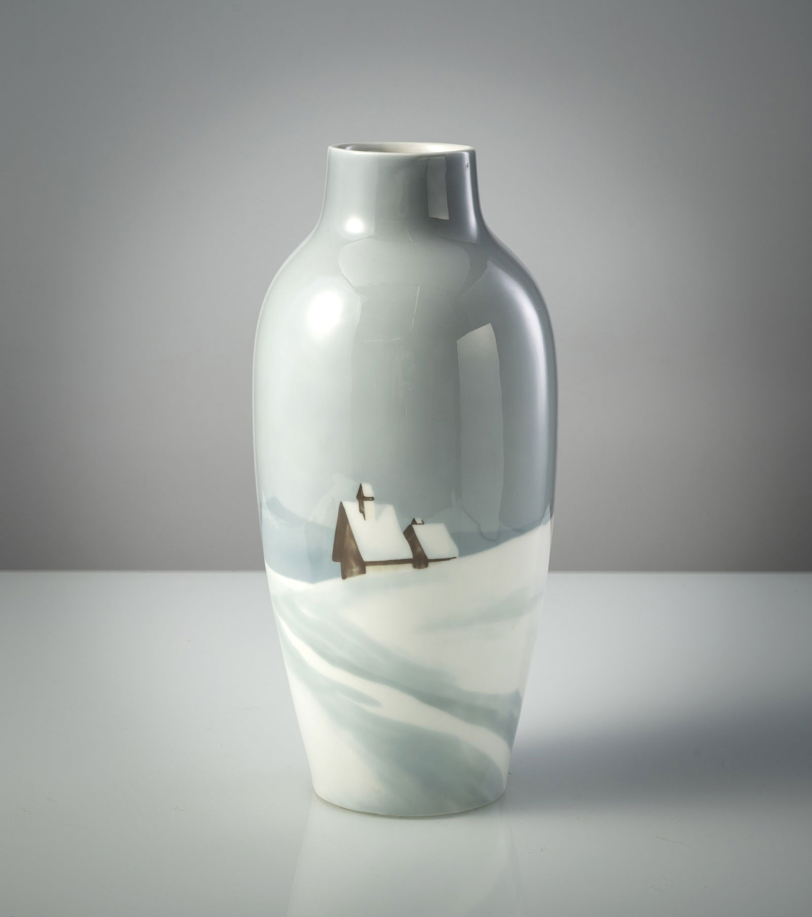 A PORCELAIN VASE WITH WINTER LANDSCAPE: A PORCELAIN VASE WITH WINTER LANDSCAPE J. and C. Copenhagen, mid 20th century H. 36 cm Painted with a rural house in a wide winter landscape. Green manufactory mark to bottom and incised mark. Minor