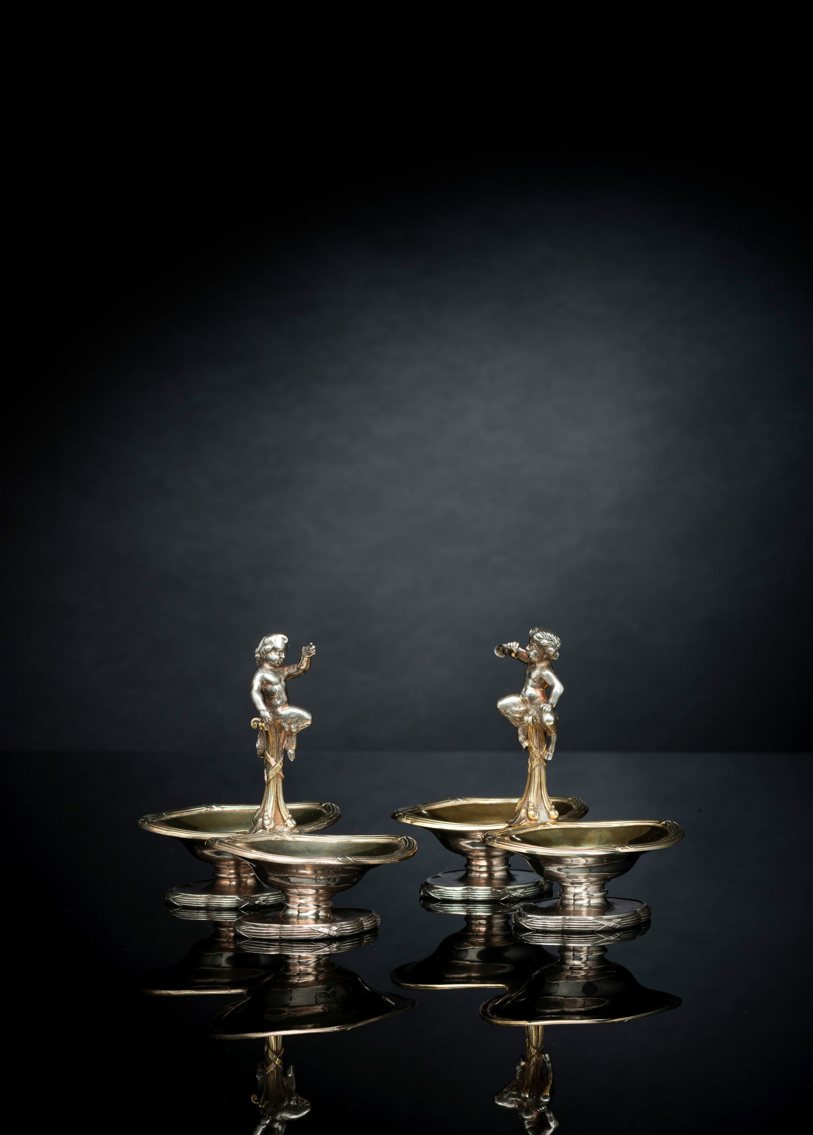A PAIR OF FRENCH PARCEL GILT SILVER SPICE STANDS WITH PUTTI: A PAIR OF FRENCH PARCEL GILT SILVER SPICE STANDS WITH PUTTI 2nd half of the 19th century H. 13,5 cm Both with French marks, one marked "ODIOT A PARIS 2279" and with company's mark. Tog.c. 636 grams.