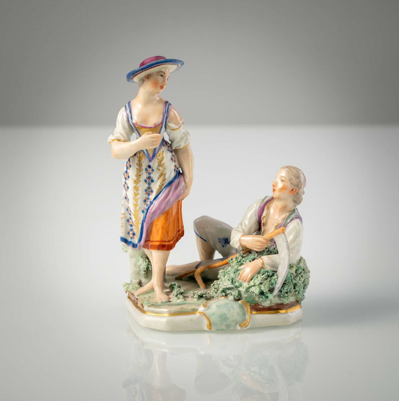 A LUDWIGSBURG PORCELAIN GROUP OF A PAIR OF HARVESTERS: A LUDWIGSBURG PORCELAIN GROUP OF A PAIR OF HARVESTERS circa 1765/70 H. 13 cm Polychrome painted, blue cc mark, min. chips, minor restoration. Flach no. 112Heubauern-Paar Ludwigsburg, um 1765/70 H. 13