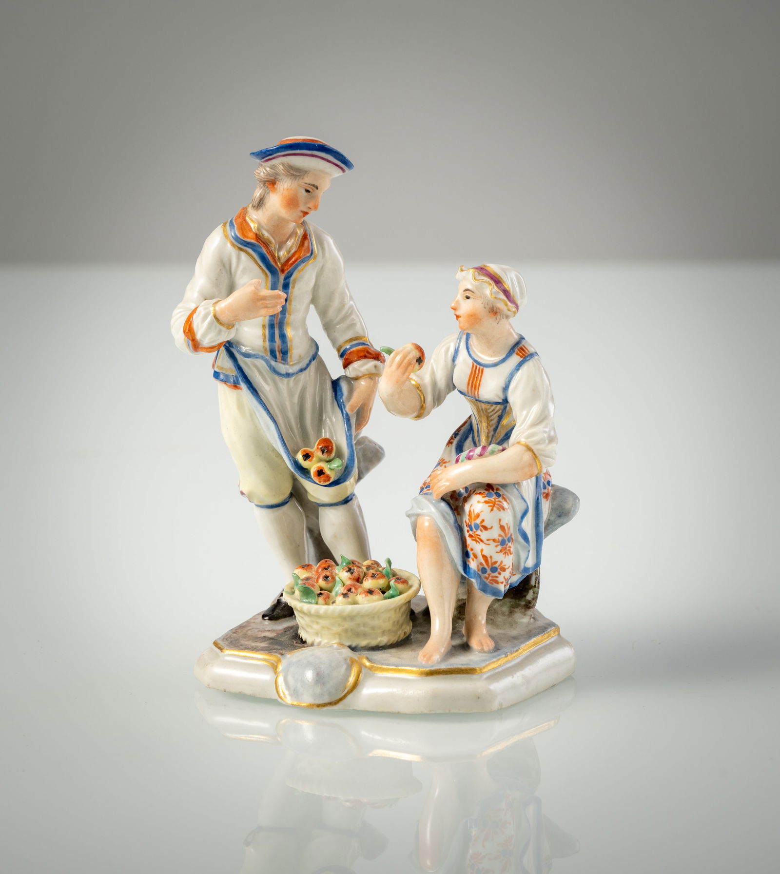 A LUDWIGSBURG PORCELAIN GROUP OF A PAIR OF FRUIT FARMERS: A LUDWIGSBURG PORCELAIN GROUP OF A PAIR OF FRUIT FARMERS circa 1765/70 H. 13 cm The model by Johann Adam Bauer (ca. 1765/70, Flach No. 114). Polychrome painted, blue CC mark, minor restorations.Paar