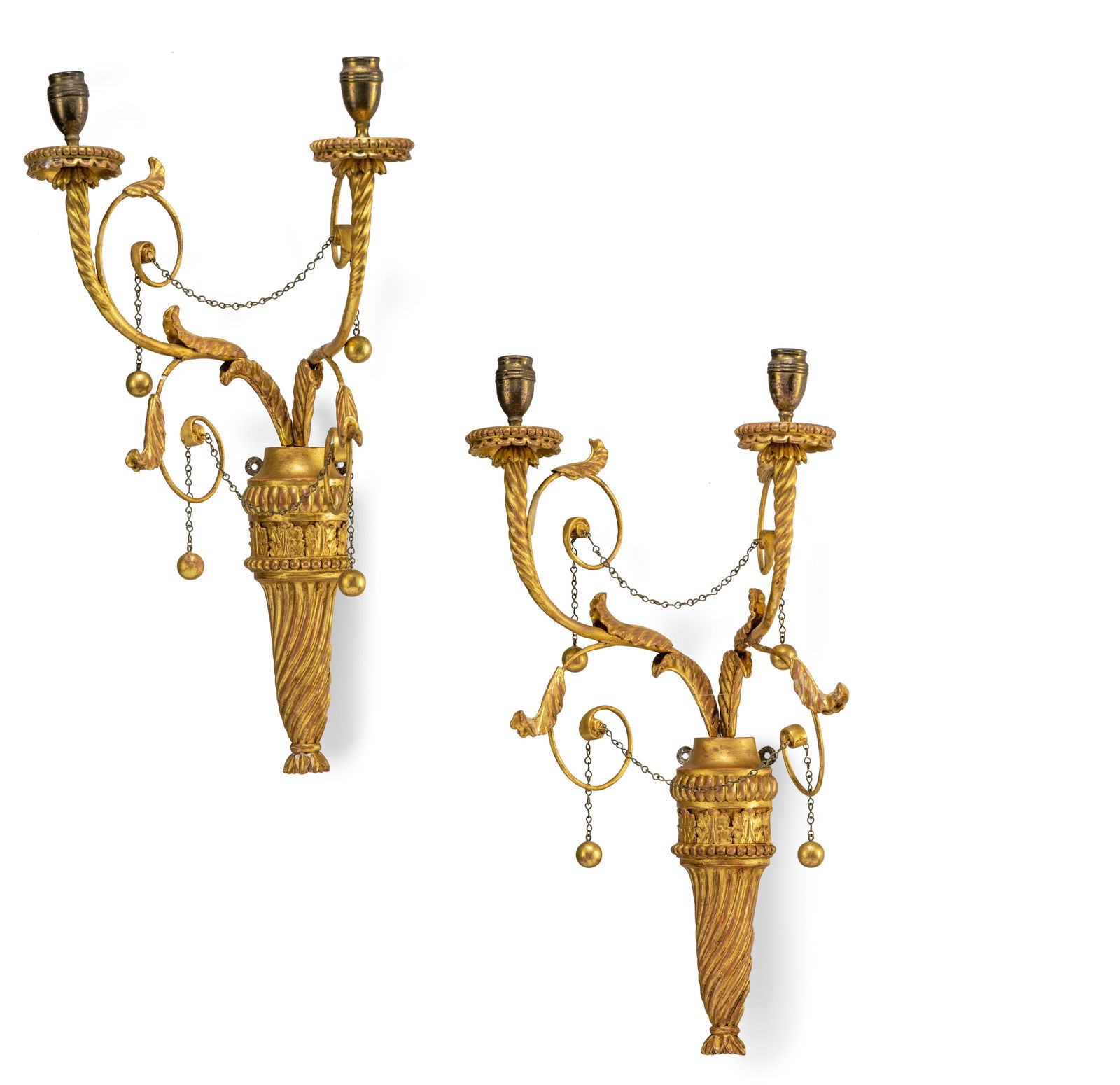 A PAIR OF GILTWOODTWO LIGHT WALL APPLIQUES: A PAIR OF GILTWOODTWO LIGHT WALL APPLIQUES circa 1800, possibly Italy H. 53 cm Each of torch shape issuing two spirally turned arms, minor losses, the bobeches later Private Collection,