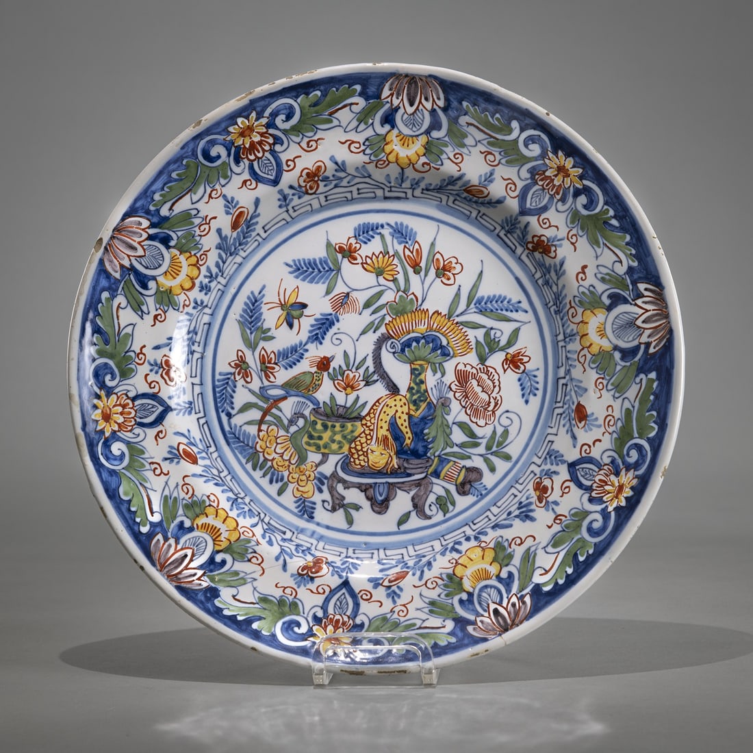 AN ASIAN STYLE FLORAL TOOLED FAYENCE PLATE: AN ASIAN STYLE FLORAL TOOLED FAYENCE PLATE Coburg or Friedberg (?) D. 28 cm Blue CB Mark with a star.Fayence-Teller Coburg oder Friedberg (?) D. 28 cm Teller bemalt in Blau, Grün, Mangan Rot und