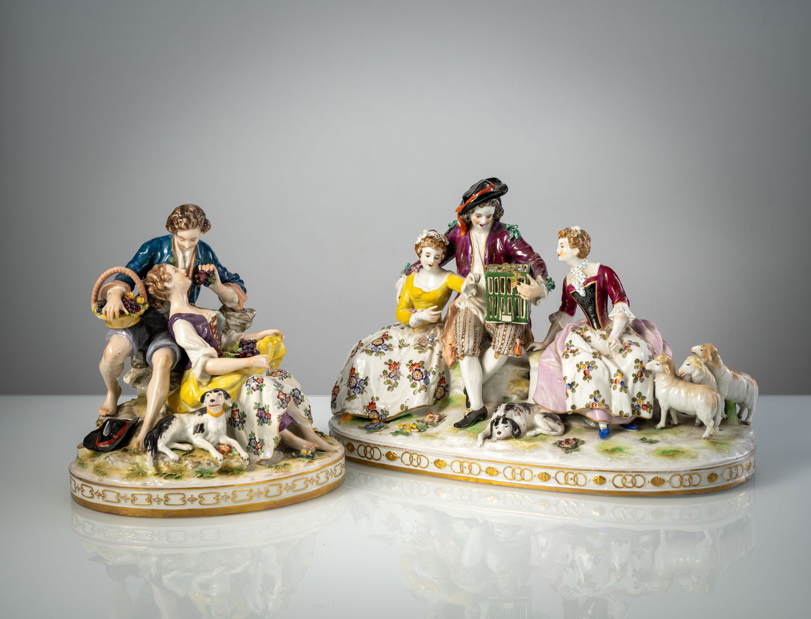 TWO GROUPS OF SHEPHERDERS: TWO GROUPS OF SHEPHERDERS Thuringia, 20th century H. 23/B. 23-37 cm Polychrome painted, blue manufactory marks. Minor chips and a hairline crackZwei Schäfergruppen Thüringen, 20. Jhdt. H.