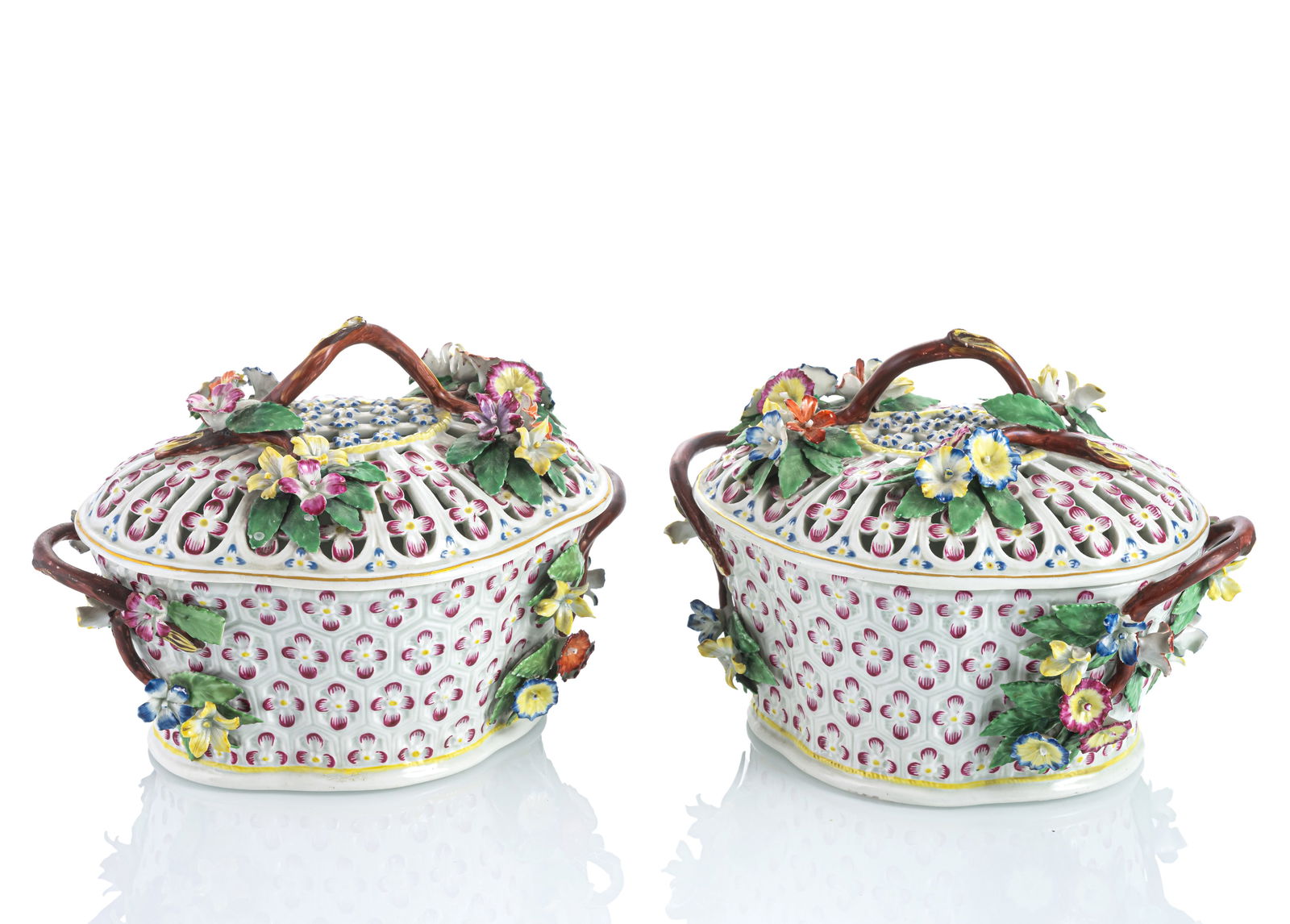 A PAIR OF EUROPEAN PORCELAIN CHESTNUT TUREENS AND COVERS: A PAIR OF EUROPEAN PORCELAIN CHESTNUT TUREENS AND COVERS 2nd half 18th century H. 14/L. 19,5 cm Matching bowls with floral pattern and handles with applied flowers, openworked lids. Numbers in